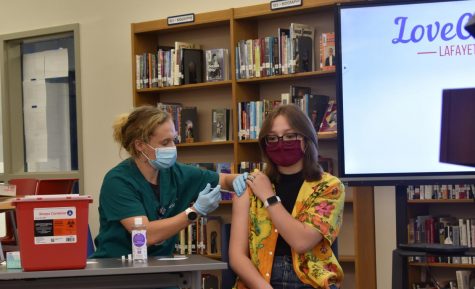 Lexington, KY. Lauren Clay Sampson, 10th grader receiving her first dose of the Covid-19 vaccination at Lafayette High School on the last day of school.