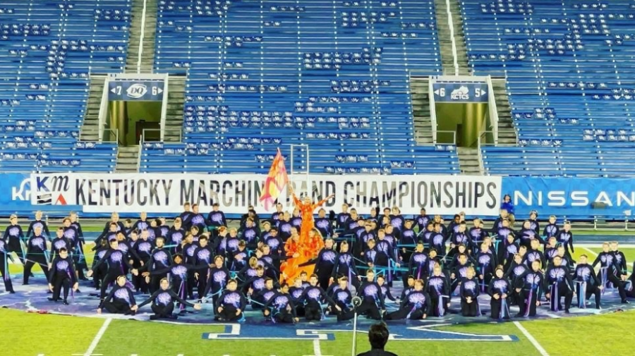 Jade Fitch, pictured in the orange, waves a flag during the post show of the Lafayette Band's State performance at Kroger Field