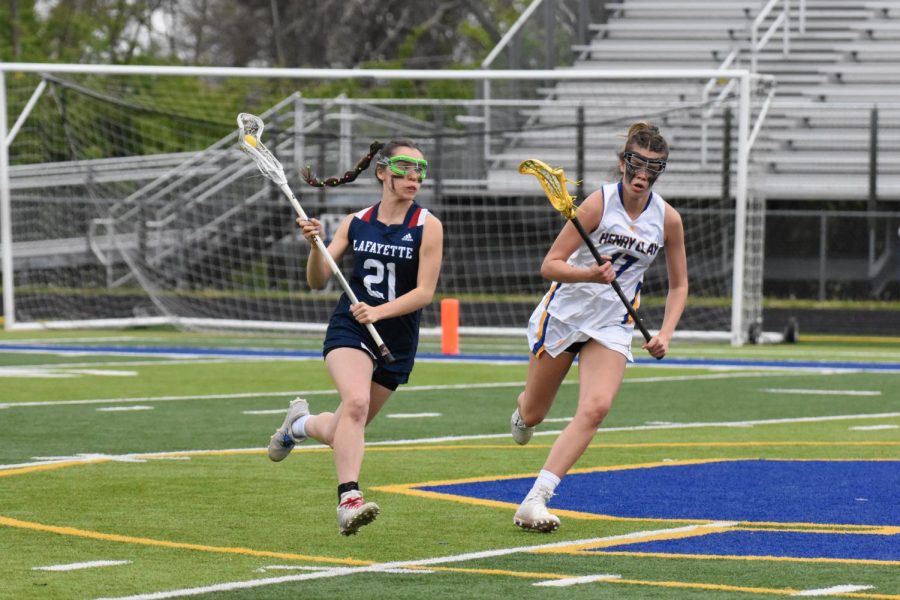 [LEXINGTON, KY] (21) Lucy Griffeth runs upfield during Lafayette High School's Varsity Girls Lacrosse game against Henry Clay. Henry Clay won 21-6.