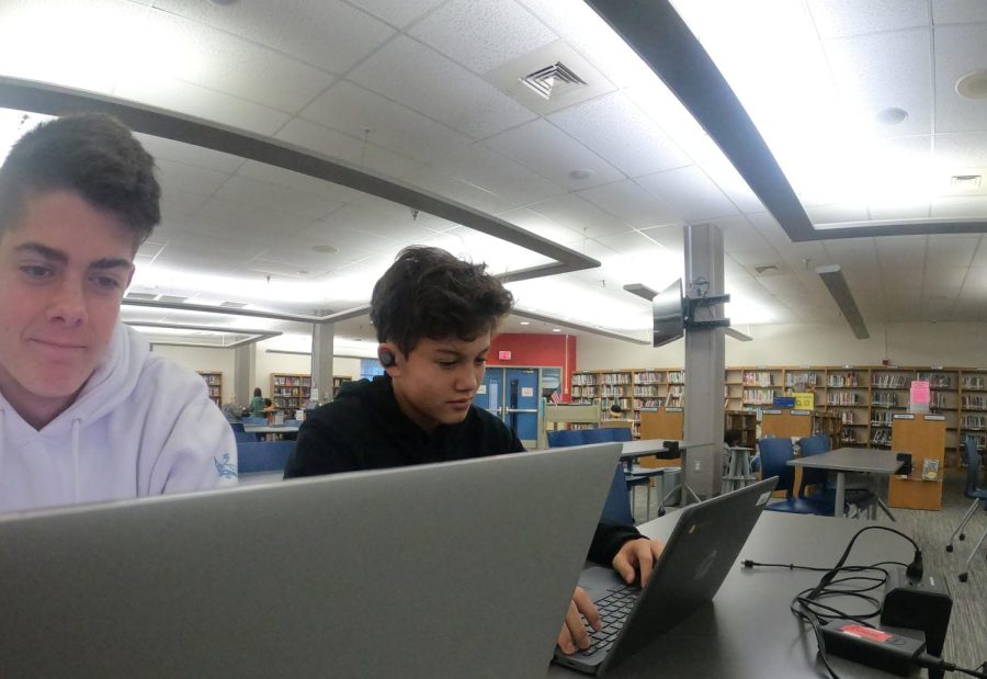 Davis Ashmun (Left) and Charles Mooney (Right) working on homework in the library while listening to music.