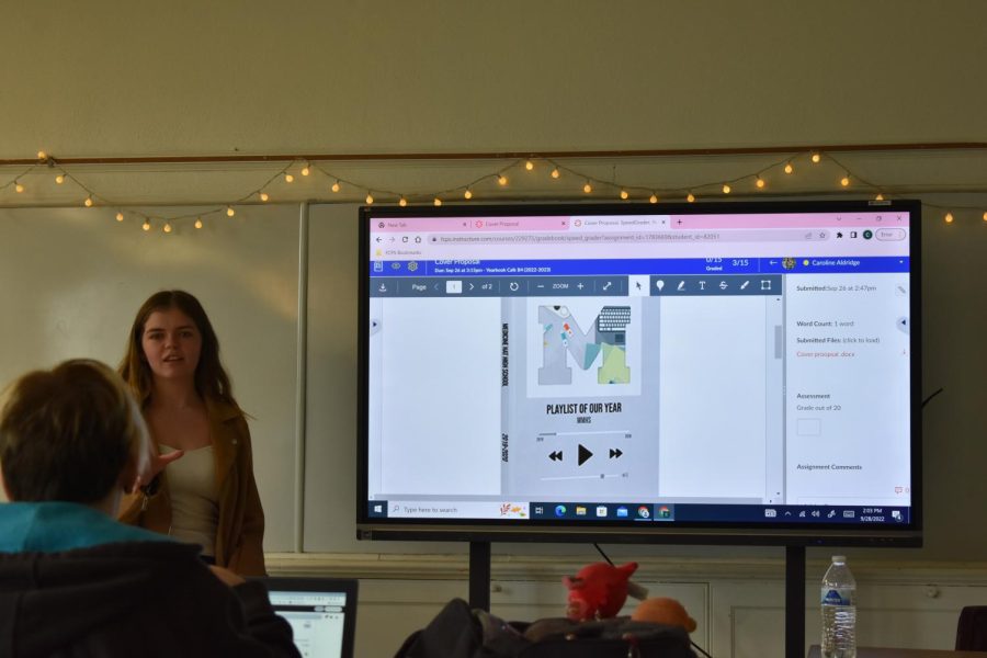 Junior Caroline Aldridge presents her idea for this years yearbook cover to the staff.