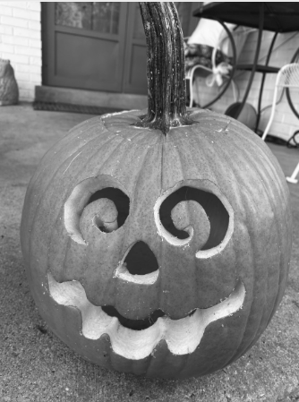 Jack-o-lantern outside on a chilly fall night.