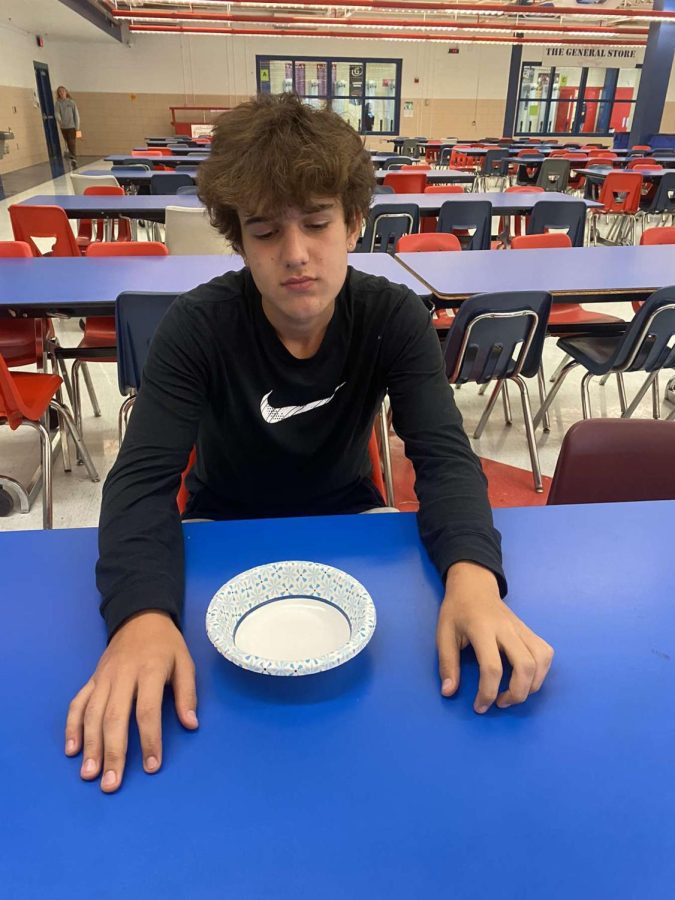 Lexington, KY. Sophomore Mustafa Mohammad sitting at lunch without any food.
