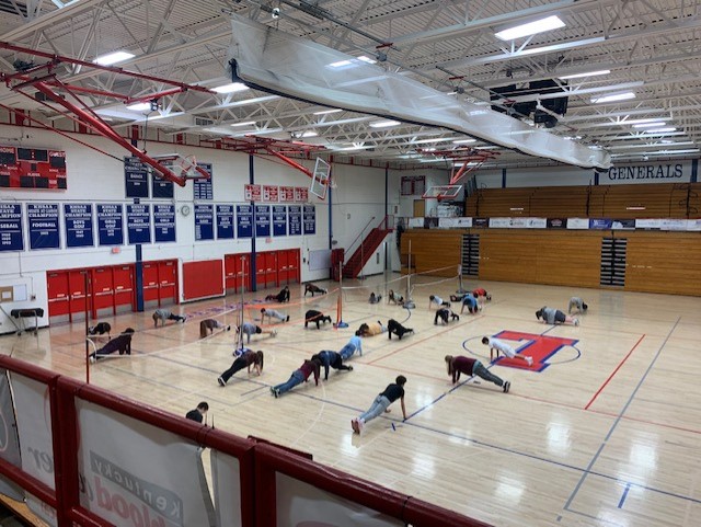 Image of a gym class in session. The volleyball tryouts will be held in the gym.
In this photo you see a class warming up in Lafayettes gym preparing for their next activity.
