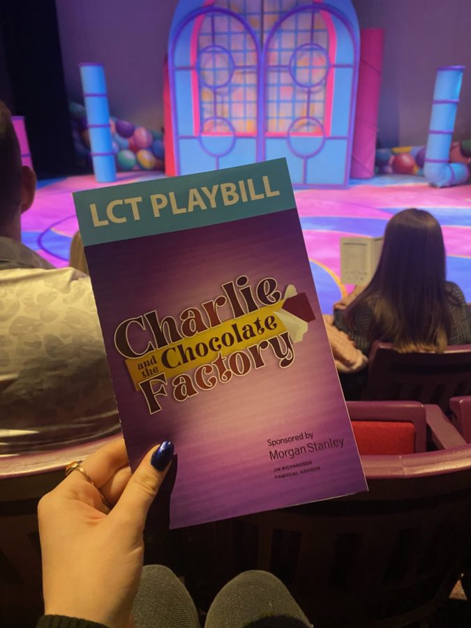 Lexington, KY. A playgoer displays the playbill for Lexington Childrens Theaters Charlie and the Chocolate Factory in front of the set for the show.