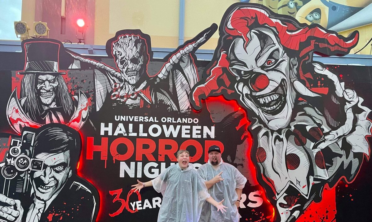 Logan Gwynn and his Dad posing out front of the Universal Orlandos Halloween Horror Nights 30 Years 30 Fears sign for their 2021 season in October of 2021.