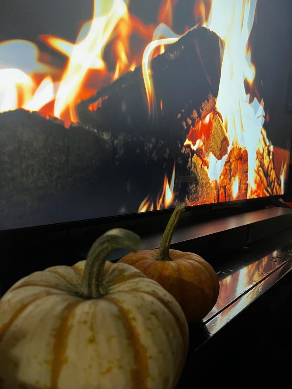 Fall pumpkins and a digital cozy fireplace, taken on 10/9/23