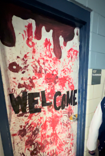 The entrance to room 137, where the haunted house took place, with a themed banner stating Welcome on it. Photo taken October 30th, 2023.