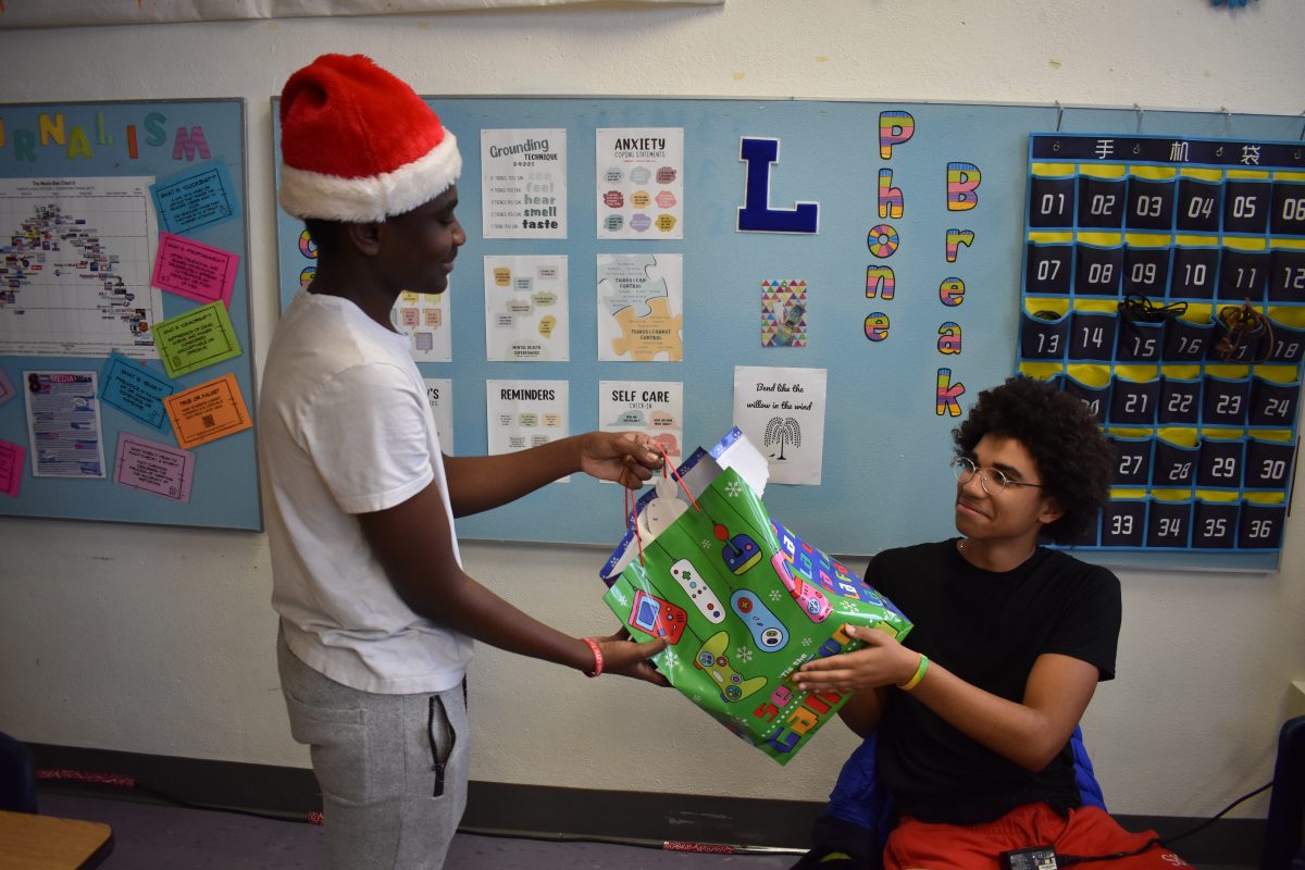 Frank+Frimpong+giving+Isaiah+Gerton+a+gift+for+Christmas.+Taken+on+December+18th%2C+2023%2C+at+Lafayette+High+School.