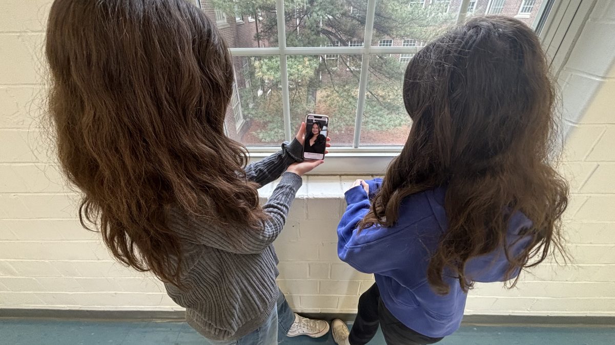 Two students looking at a photo of Gypsy Rose Blanchard. Taken in Lafayette High School, on January 29th, 2024.