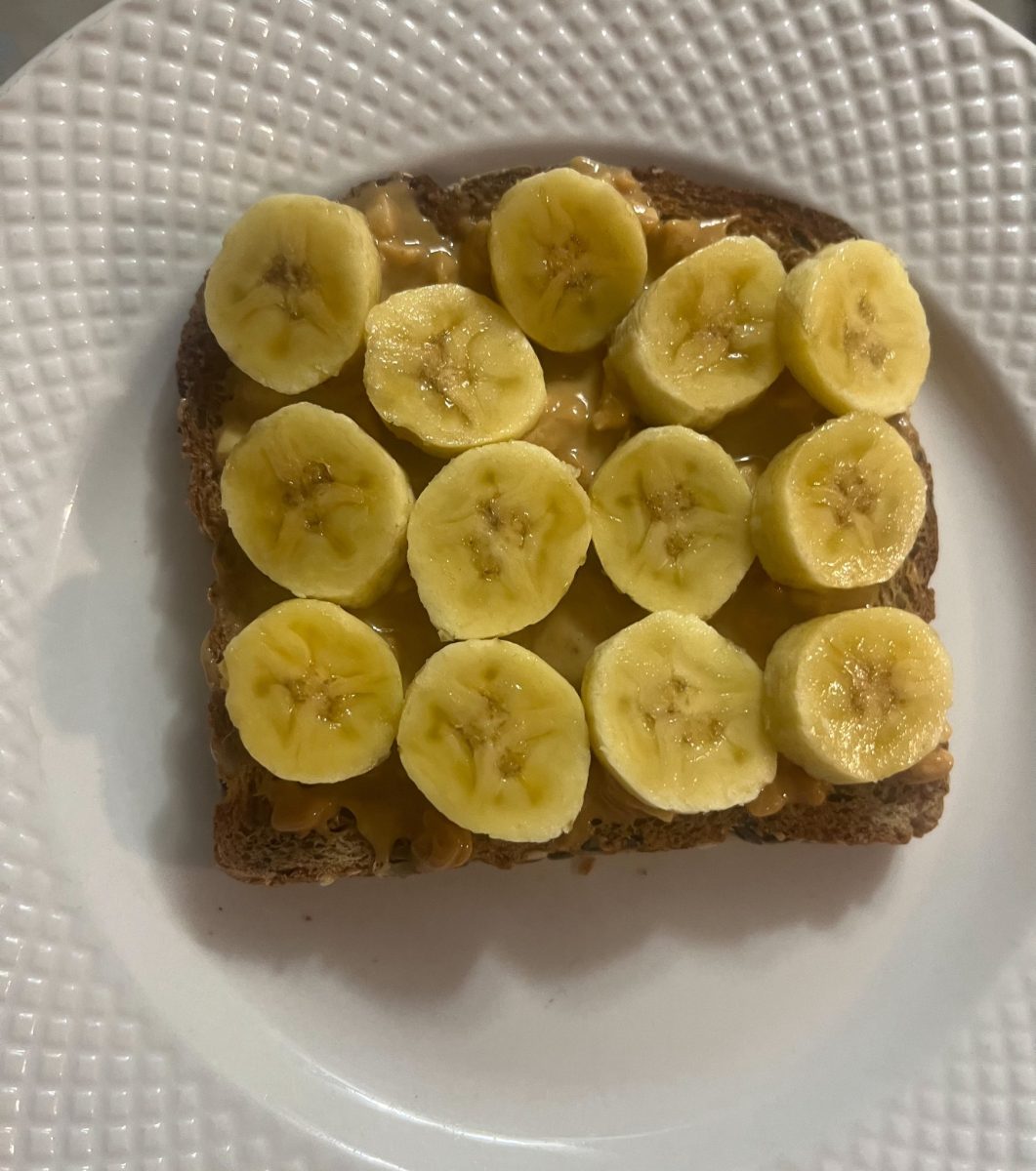 Toast with crunchy peanut butter topped of with diced mini bananas. Taken on 2/11/24 by Cynthia Guevara.