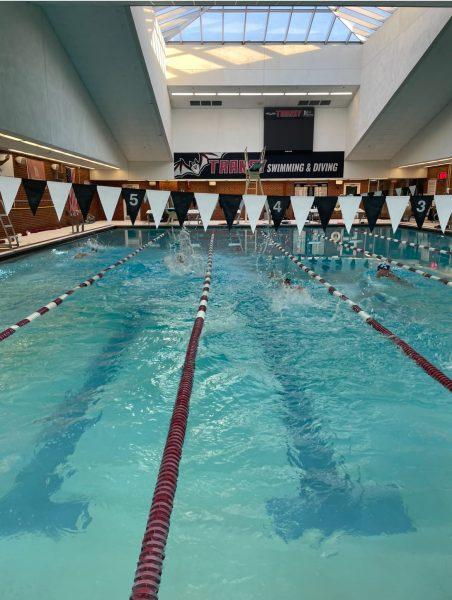 The Lafayette Swim Team jumps in the pool to warm up for their first practice of the season on October 13, 2024 at 6:09 P.M.