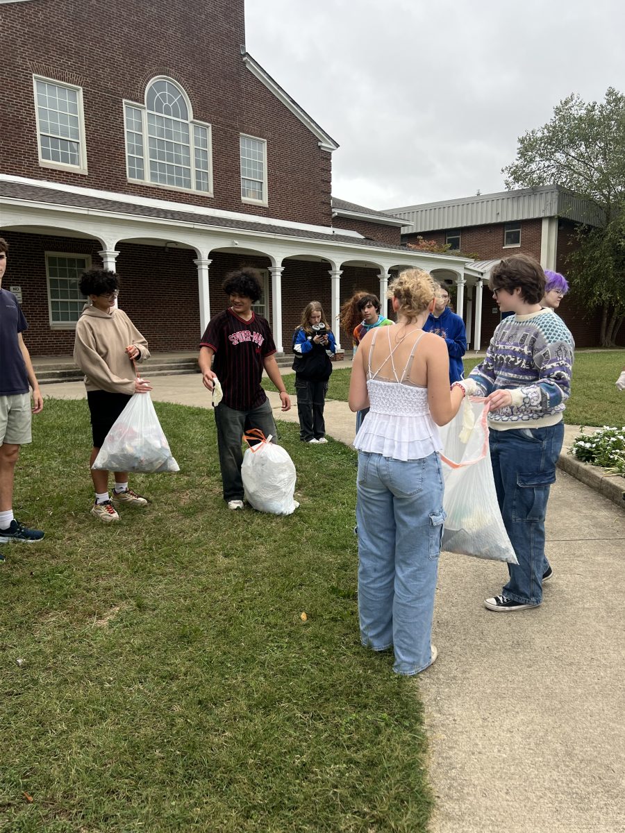 Student Y members gather in front of Lafayette School on Sept. 26 to show off their trash bags, after volunteering to clean up trash for Student Y.