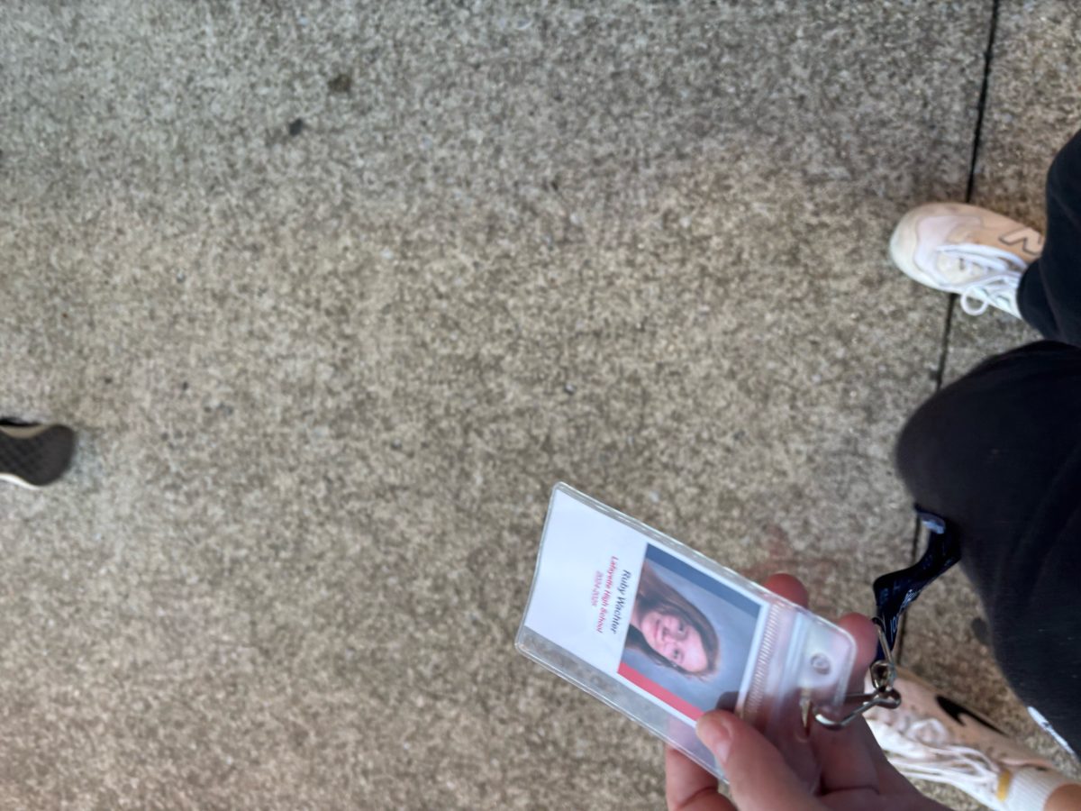 Ruby Wachter on October 8, 2024, with her badge ready to show Lafayette staff to get in the building.