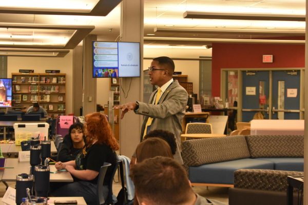 Superintendent Demetrus Liggins sharing ideas for "badges" for FCPS Elevate program that tracks milestones towards graduation. Taken on December 11th, 2024 in Lafayette's library.