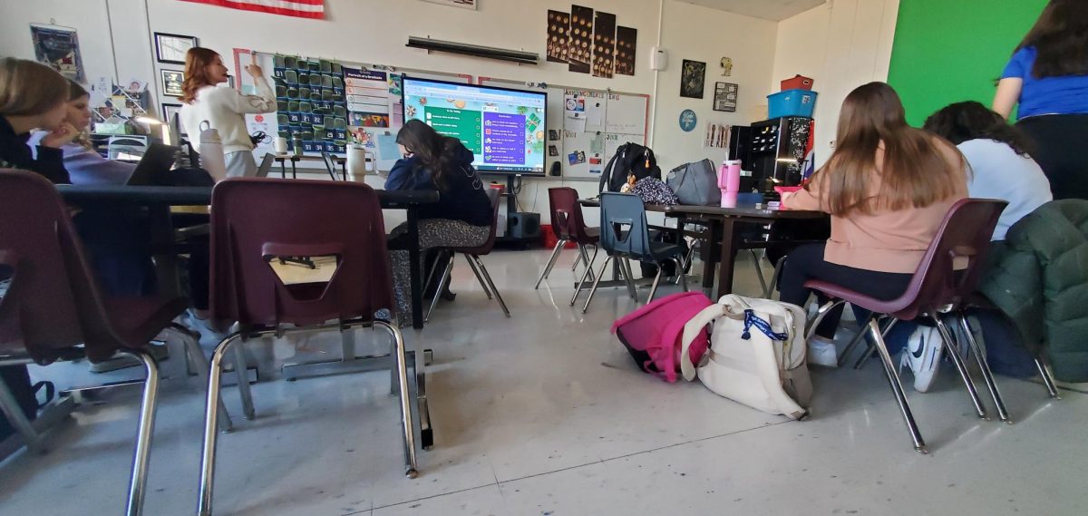 Mrs. McPherson's A4 Journalism class, one of two classes that write for the newspaper, starts the class with a staff meeting—a photo taken on December 11th.