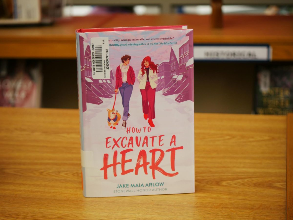 "How to Excavate a Heart" by Jake Maia Arlow, this cozy LGBTQ+ novel that follows a college freshman navigating the new environment. the story is full of humor, awkward charm, and heartfelt moments. Photo taken on 12/10.