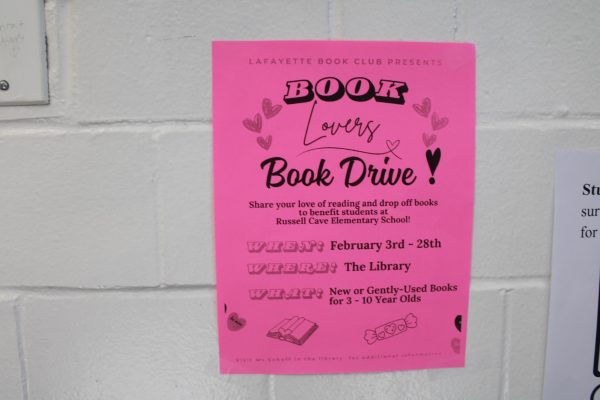 This is a photo taken on February 26 of a flyer in the hallway of our school featuring a book drive from February 3rd to 28th that will benefit kids at Russel Cave Elementary.