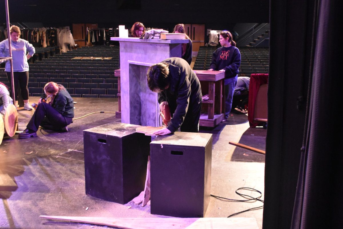 Senior Milo Osbourn sawing wood to make a set piece for Anastasia, photo taken on January 28, 2025.