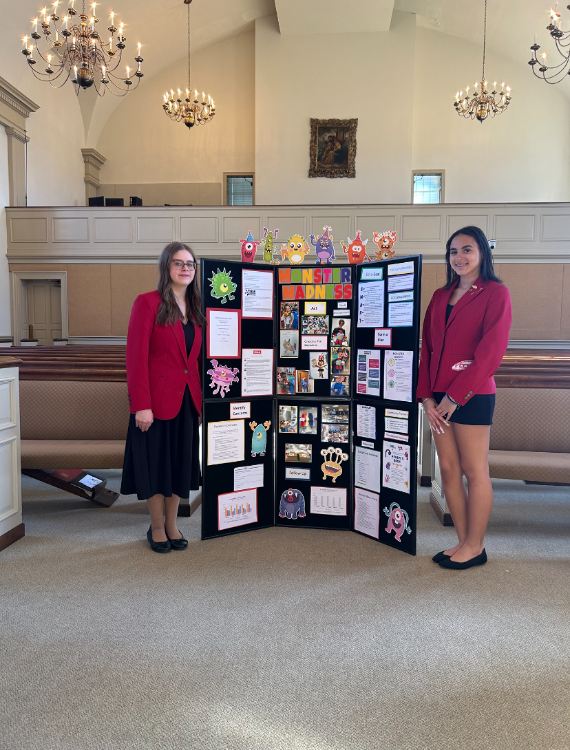 FCCLA members Marisa Presley and Deleigha Cummins standing by their project at regional competition in Danville, KY on February 28th.