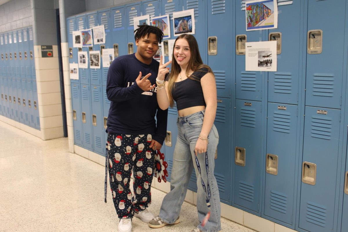 Sophomores Dominique White and Ava Broaddus at Lafayette High school on March 31st. Dominique is showing the style that a lot of teens are wearing these days: pajama pants with a loose fitting long sleeved T-shirt; a very casual style. Ava is wearing jeans and a short navy top.