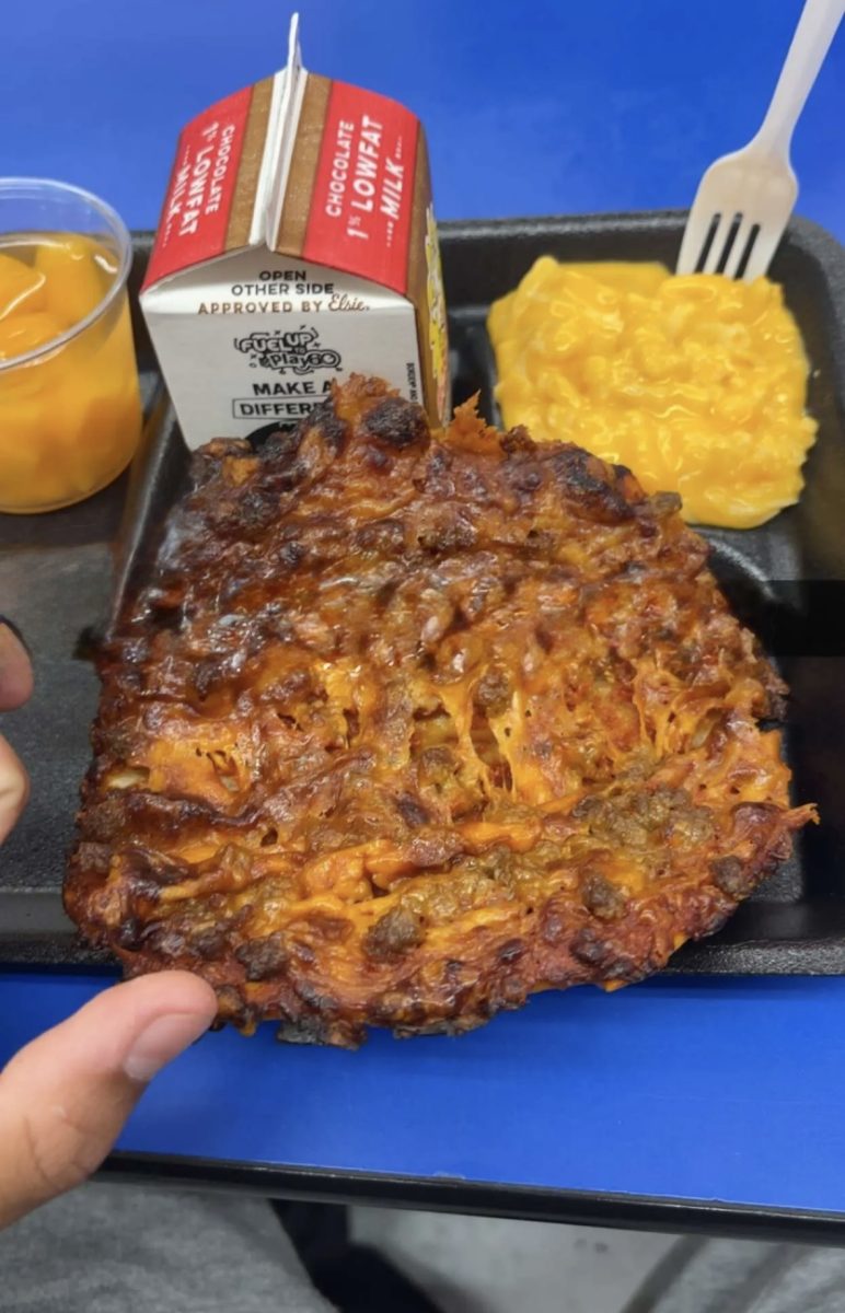 A photo of a student lunch consisting of a chicken and cheese sandwich, Mac and cheese, and peaches taken on September 20th, 2025