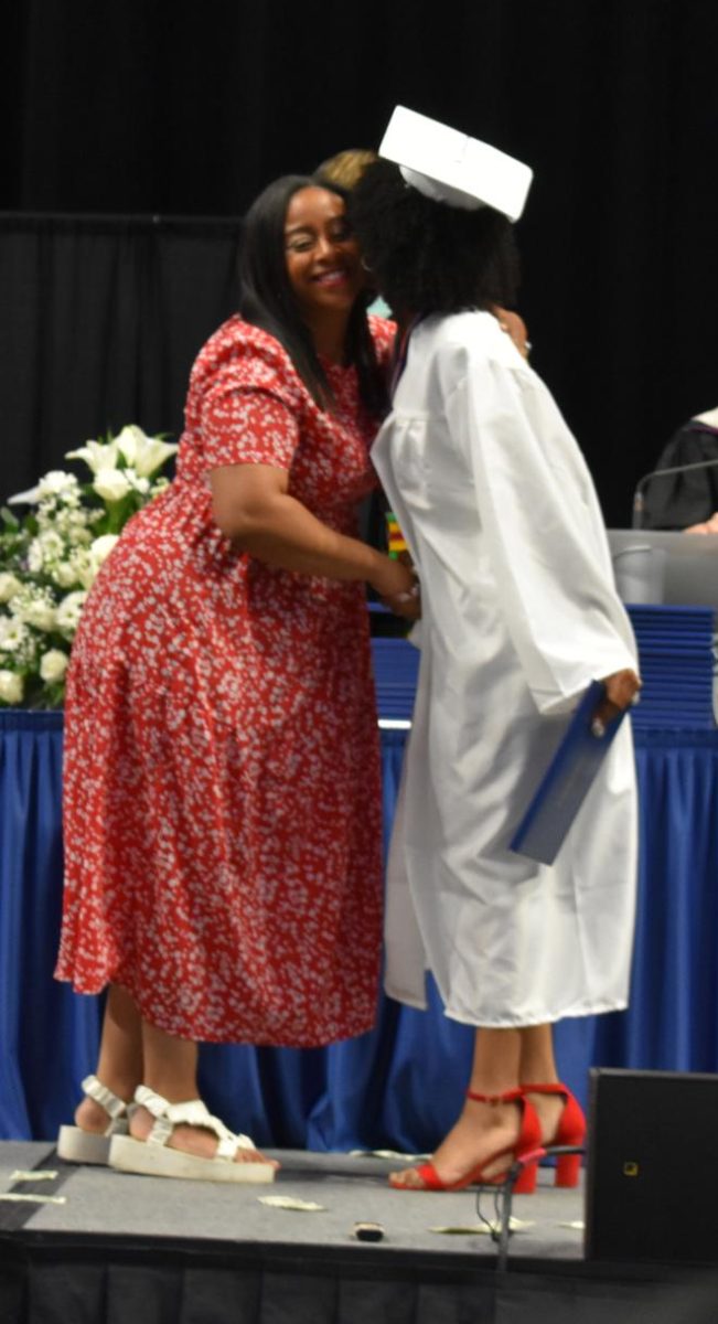 LEXINGTON, KY.  A graduate gives a family member a kiss after receiving their diploma at Lafayette's graduation ceremonies at Rupp Arena on June 4, 2026.