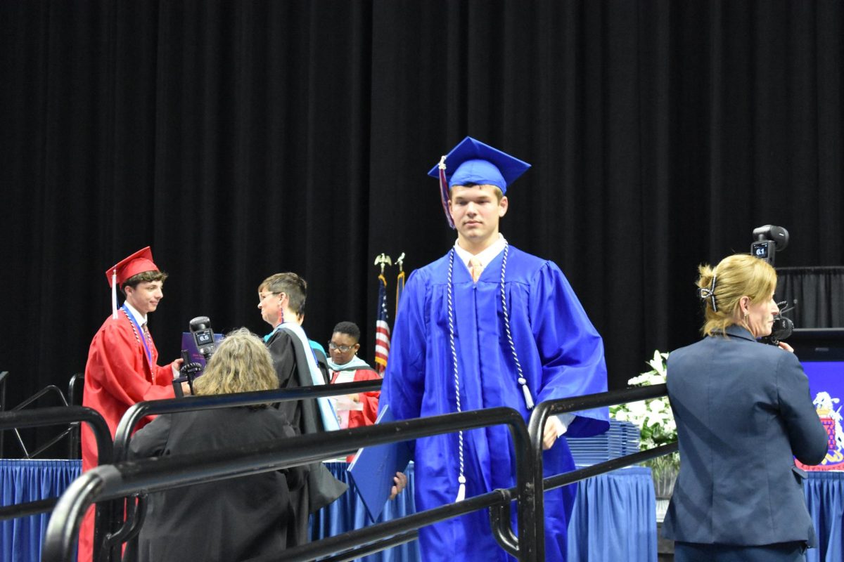 LEXINGTON, KY.  A graduate exits the stage with a diploma at Lafayette's graduation ceremonies at Rupp Arena on June 4, 2026.