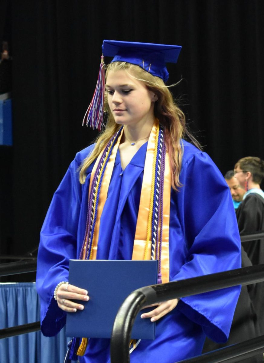 LEXINGTON, KY.  A graduate exits the stage with a diploma at Lafayette's graduation ceremonies at Rupp Arena on June 4, 2026.