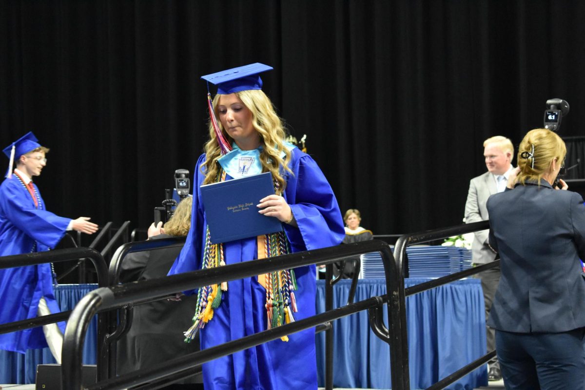 LEXINGTON, KY.  A graduate exits the stage with a diploma at Lafayette's graduation ceremonies at Rupp Arena on June 4, 2026.