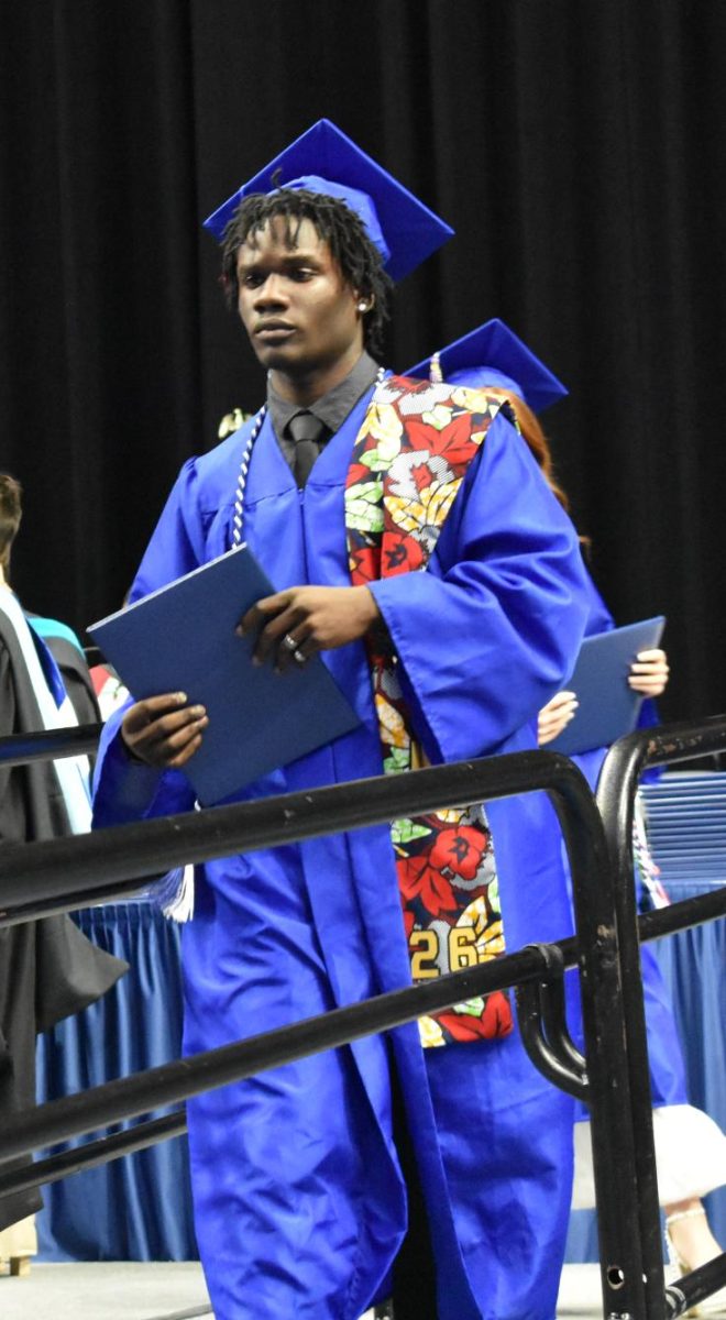 LEXINGTON, KY.  A graduate exits the stage with a diploma at Lafayette's graduation ceremonies at Rupp Arena on June 4, 2026.